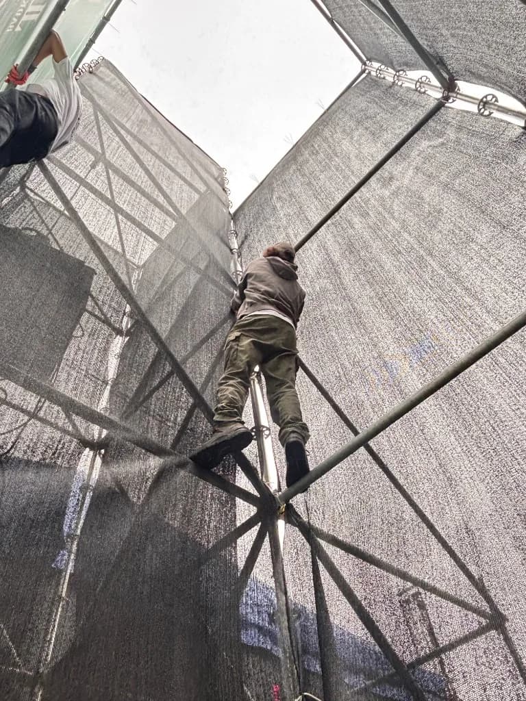 Crew klimt in scaffolding tijdens opbouw